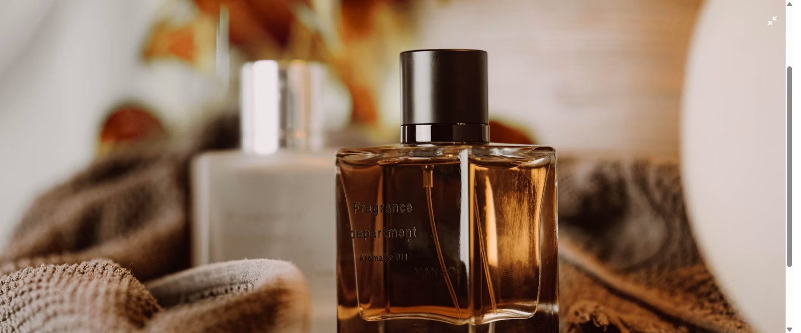 Sticle de parfum de toamnă pe un fundal cald, cu frunze uscate